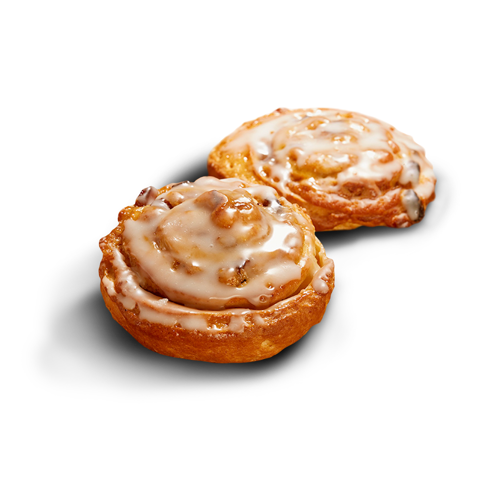 Zwei glutenfreie Rosinenschnecken mit sichtbaren Rosinen im Teig und Zuckergussglasur überzogen